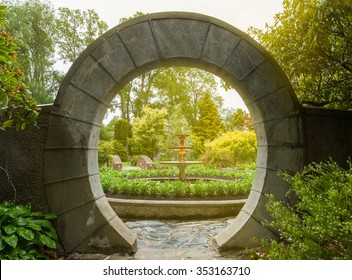 Stone Archway In Flower Garden