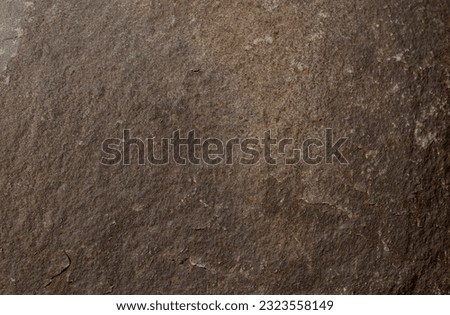 Stone background of rusty color from a single piece. Beautiful textured weathered stone background. Concept stone textured background.