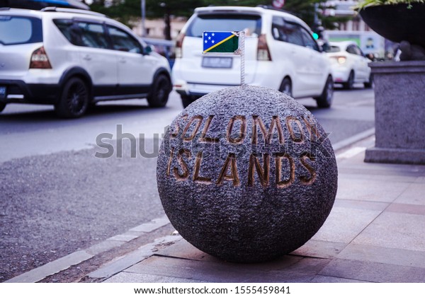 Stone balls with the country name\
of each member of Non Aligned Movement along the Asia Africa\
street, Bandung, West Java, Indonesia. In the photo: Solomon\
Islands