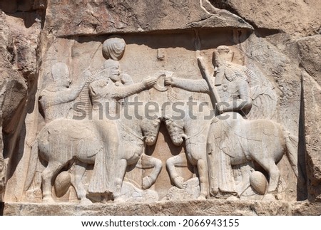 Stone bas-relief of Investiture of Ardashir I (Coronation of Ardashir I), royal tombs in ancient necropolis Naqsh-e Rustam, Achaemenid dynasty, Fars province, Iran. UNESCO world heritage site