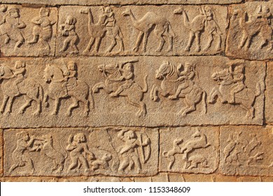 Stone bas-reliefs on the walls in Temples Hampi. Carving stone ancient background. Carved figures made of stone. Unesco World Heritage Site. Karnataka, India. Beige background. Royal enclosure.