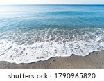 stone beach and turquiose water wave of cote dAzur at Nice at summer, Riviera, France