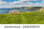 Stone bench at the South West Coast Path with a view over the Jurassic Coast and Emmett