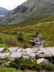 Stone Bridge Across Stream In Beautiful Valleys Of Scottish Highlands. High Quality Photo