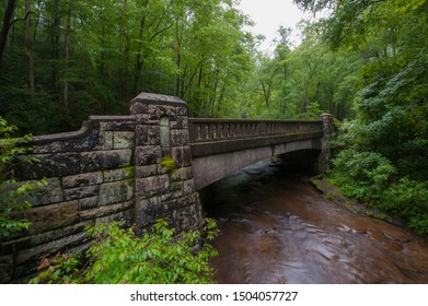 Stone Bridge In Brevard, NC In Forest With River Running Under It.