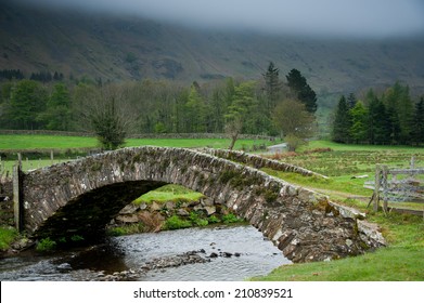 Stone bridge crosses a stream in the English Lake District
