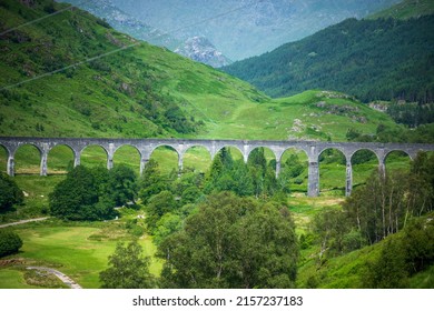 A stone bridge going through the field