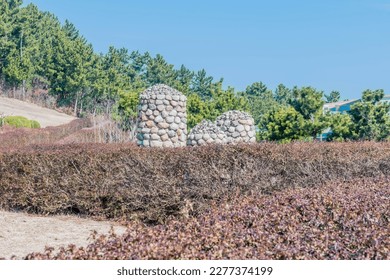 Stone cairn in urban park on sunny winter morning. - Shutterstock ID 2277374199