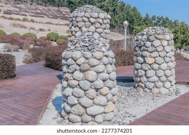 Stone cairn in urban park on sunny winter morning. - Shutterstock ID 2277374201