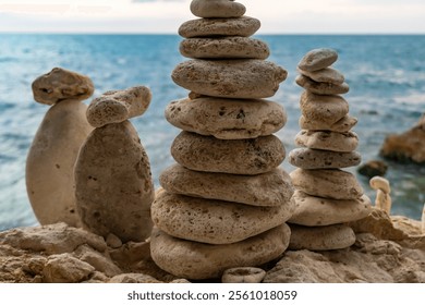 Stone Cairns Beach Ocean - Three stone cairns stacked on a sandy beach by the ocean. - Powered by Shutterstock