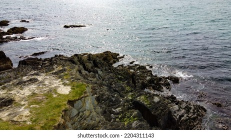 Stone Cape Of The Coast Of Ireland, Top View. Rocky Seashore In Sunny Weather. Nature Of Northern Europe.