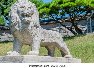 Stone Carved Lion On Concrete Plinth At Entrance To Public Park.