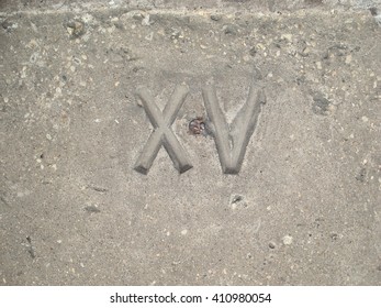 Stone Carved Roman Numeral XV - Powered by Shutterstock