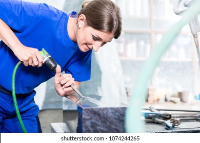 Stone Carver Working On Gravestone With Compressed Air Chisel