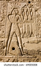 Stone Carving Of The Ancient Egyptian God Of The River Nile Hapi.  Shown Wearing A Crown Of Lotus Flowers.  Wall Of The Temple Of Seti I, West Bank Of The Nile, Luxor, Egypt.