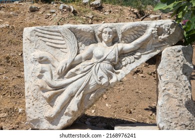 Stone carving of goddess Nike, Ephesus or Efes, Kusadasi, Turkey. Marble relief of winged Nike Goddess of Victory Ephesus Turkey. Carved marble statue. Sculpture of goddess Nike in archaeological site