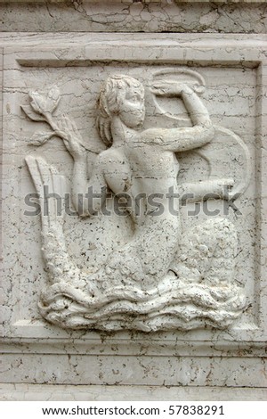 Stone carving of a mermaid on the monument infront of the Franciscan Church of the Redentore on Guidecca, Venice.