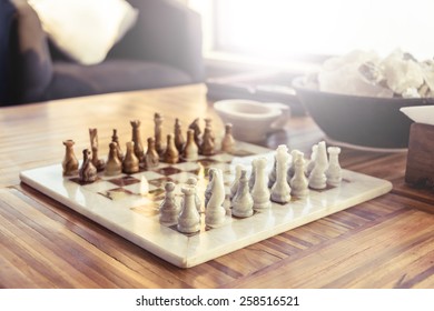 Stone Chess Game On A Wooden Table