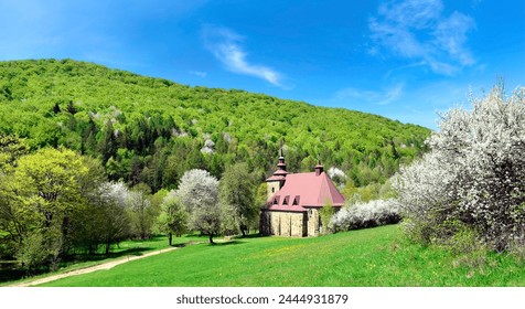 A  stone church in the picturesque landscape in Huta Polanska of the Low Beskids (Beskid Niski) in spring sunny day, Poland - Powered by Shutterstock