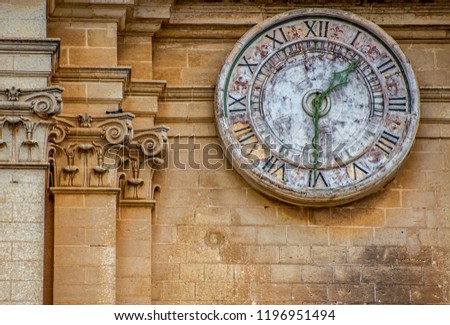 Stone clockface in Mdina.