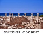 stone columns standing among the ruins of ancient buildings in the archaeological park of Paphos city, Cyprus