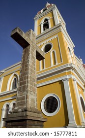 Stone cross next to the yellow cathedral in central Granada Nicaragua