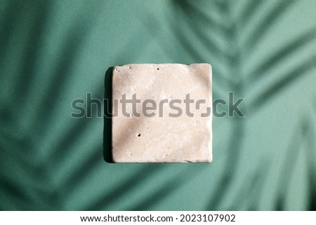 stone display flat lay podium ongreen background and palm shadow. Product promotion Beauty cosmetic showcase.
