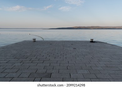 Stone dock in Adriatic sea near Baska Voda, Croatia at summer morning - Shutterstock ID 2099214298