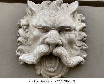 Stone Face Of An Ugly Monster With A Big Mustache