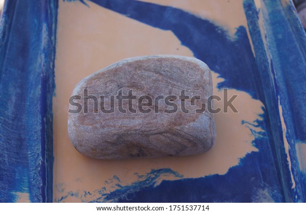 A stone with\
a fancy ornament on the\
surface.