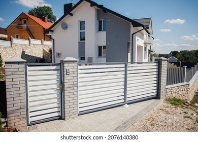 Stone Fence And Iron Gates On A Rural Street