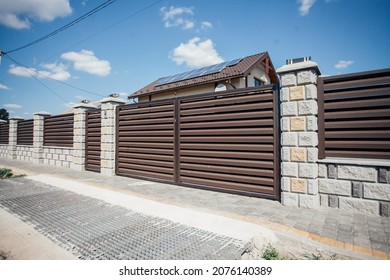 Stone Fence And Iron Gates On A Rural Street