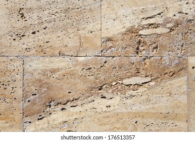 Stone finishing of a wall. Stone texture of warm colors. The best designers background. Marble, granite, coquina.