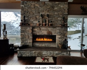 Stone Fireplace with Flames a-Glow, Rustic Style in Brown and Grey Tones, Cozy Home in Winter - Shutterstock ID 794452294