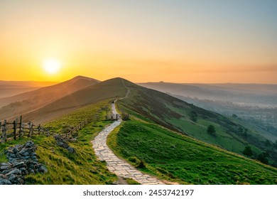 Stone footpath and wooden fence leading a long The Great Ridge in the English Peak District - Powered by Shutterstock