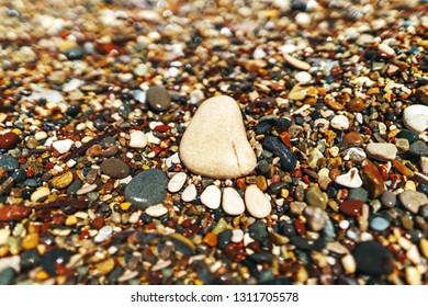 Stone footprint on the beach at the sea - Shutterstock ID 1311705578