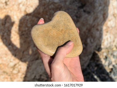 Stone in a form of heart in woman hand