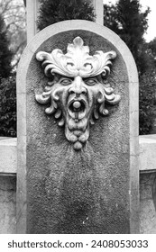 Stone fountain with decorative demon face in Alarcon town, Cuenca, Spain