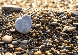 Stone Heart On Pebble Beach, Shining Ocean Water, Rocky Shore Love Symbol, Summer Pebble Heart, Vacation Concept, Blurred Texture Background