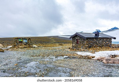 Stone hut cottage at Galdhøpiggen snow-covered in summer in Jotunheimen Lom in Norway is the largest and highest mountain in Norway and Scandinavia with 2469 meters.