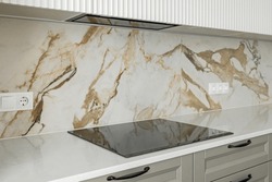 Stone Kitchen Table Top With Electric Stove And Hood, Against A Marble Tiled Wall, Design, Copy Space