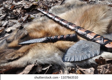 
Stone knife and ax on the skin of a wolf
