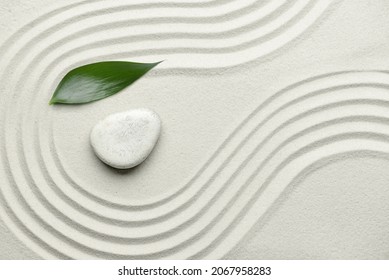 Stone and leaf on sand with lines. Zen concept - Powered by Shutterstock