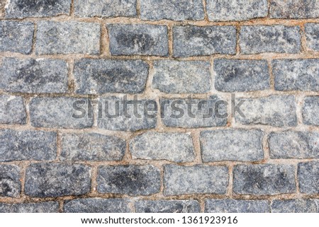 Stone lined with granite walls. sandstone. stone background wall. Natural stone masonry. Faceted square stone. High resolution.