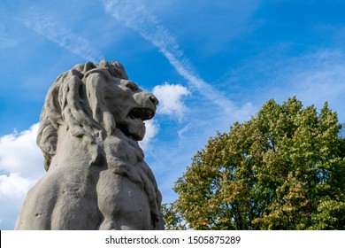 A stone lion on the entrance to the walk way bridge at Antwerpen port, tourists can look out over the River Scheldt. Tourist attraction background