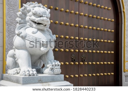 Stone Lion statue in front gate of Temple. Stone lion in China. Stone lion statue of wood gate.
