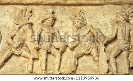 A stone low relief depicting the gladiators in action