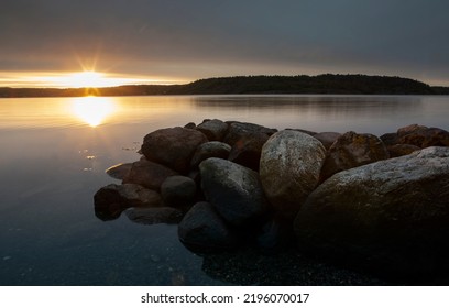 Stone and low water tide with sunrise and fjord in southern Norway - Shutterstock ID 2196070017