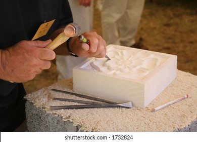 Stone Mason At Work Carving An Ornamental Relief