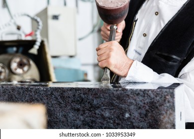 Stone Mason Working On Tombstone In His Workshop